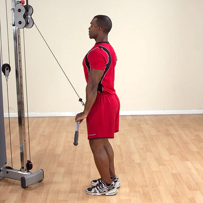 Man in red workout gear performing cable tricep pushdown in gym.