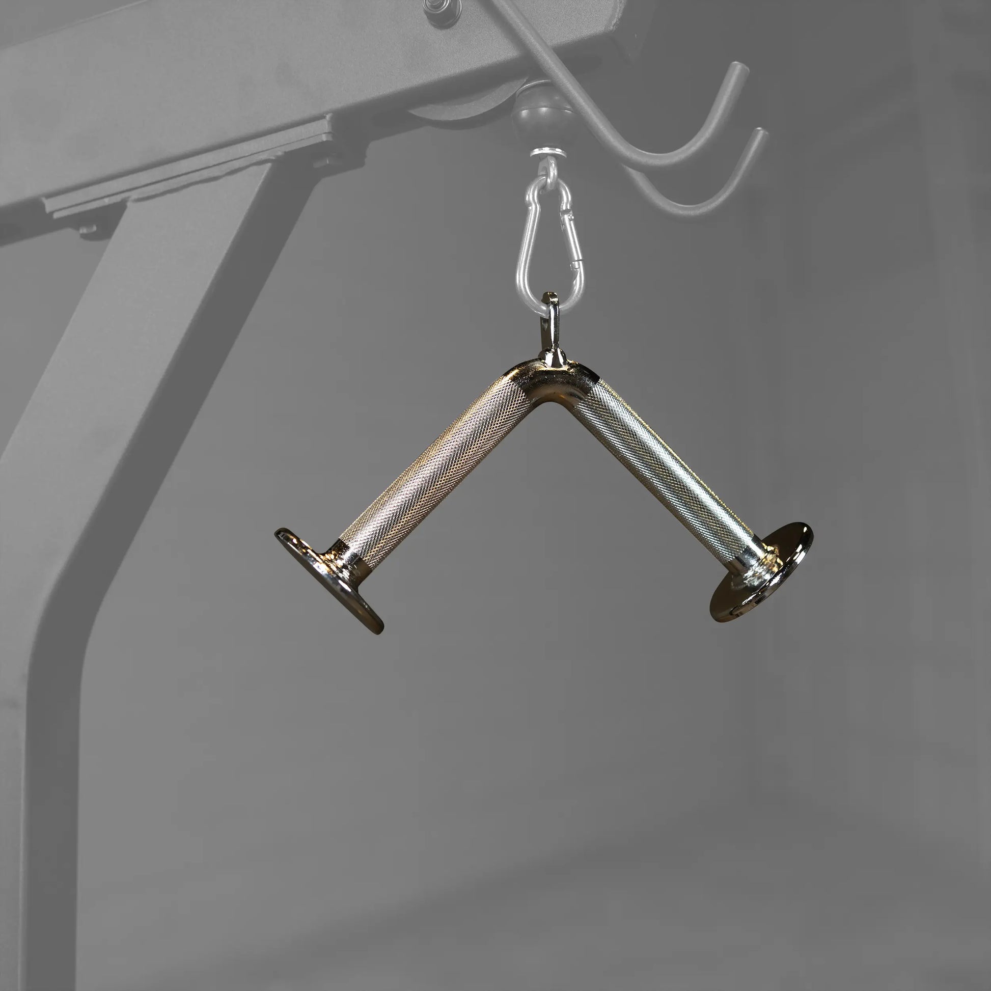 Chrome cable machine attachment with knurled handles for gym workouts.
