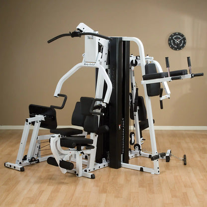 Body-Solid home gym with multi-station setup, featuring padded black seats and white frame.