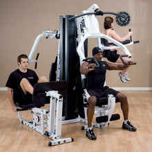 People using Body-Solid home gym machine for full-body workout.