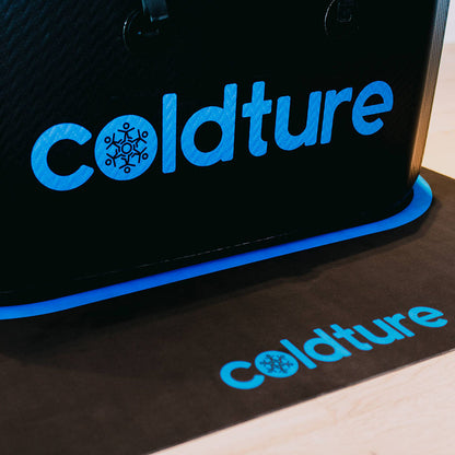Close-up of the Coldture Dry Mat featuring the brand name 'coldture' in blue against a black background.