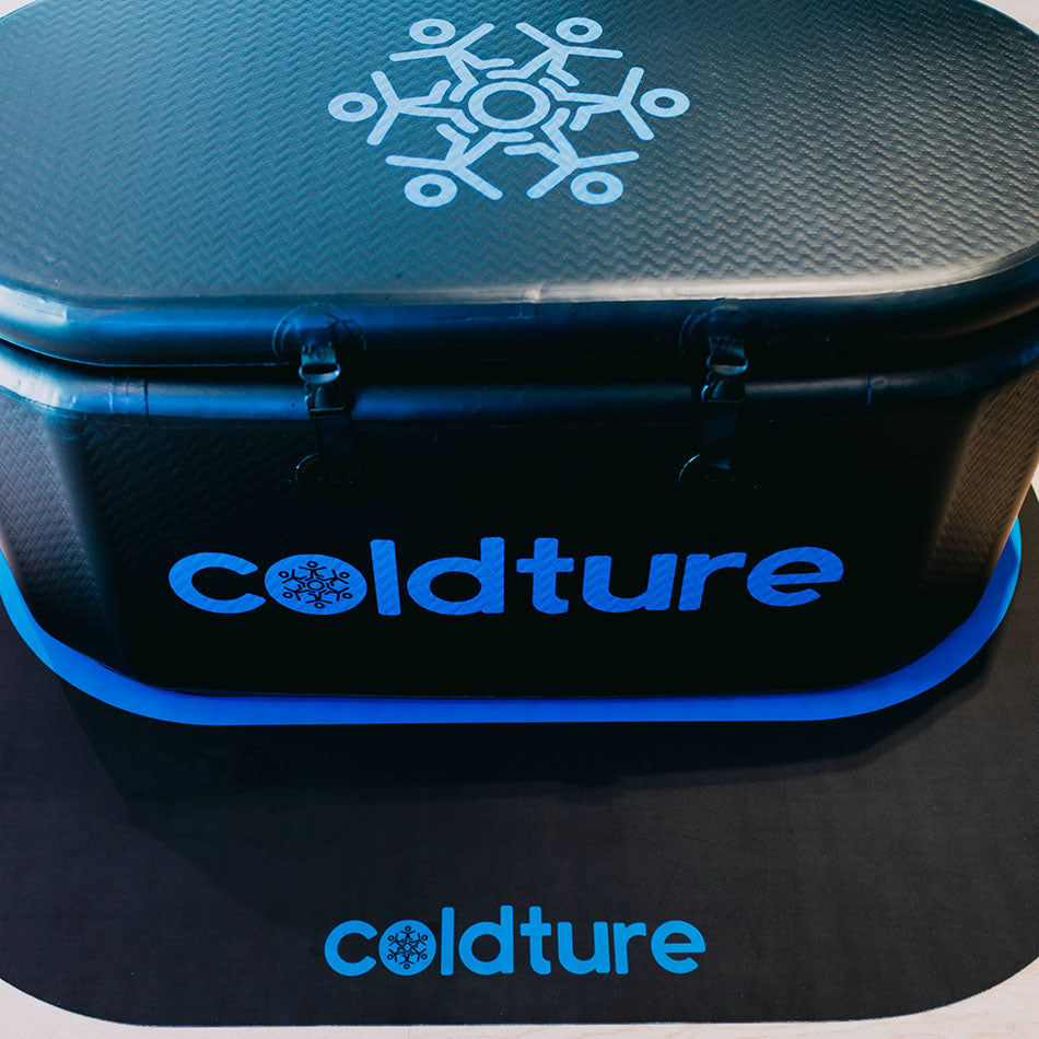 Image of a Coldture Dry Mat placed underneath a black, oval-shaped container with the Coldture logo prominently displayed on the side and top.