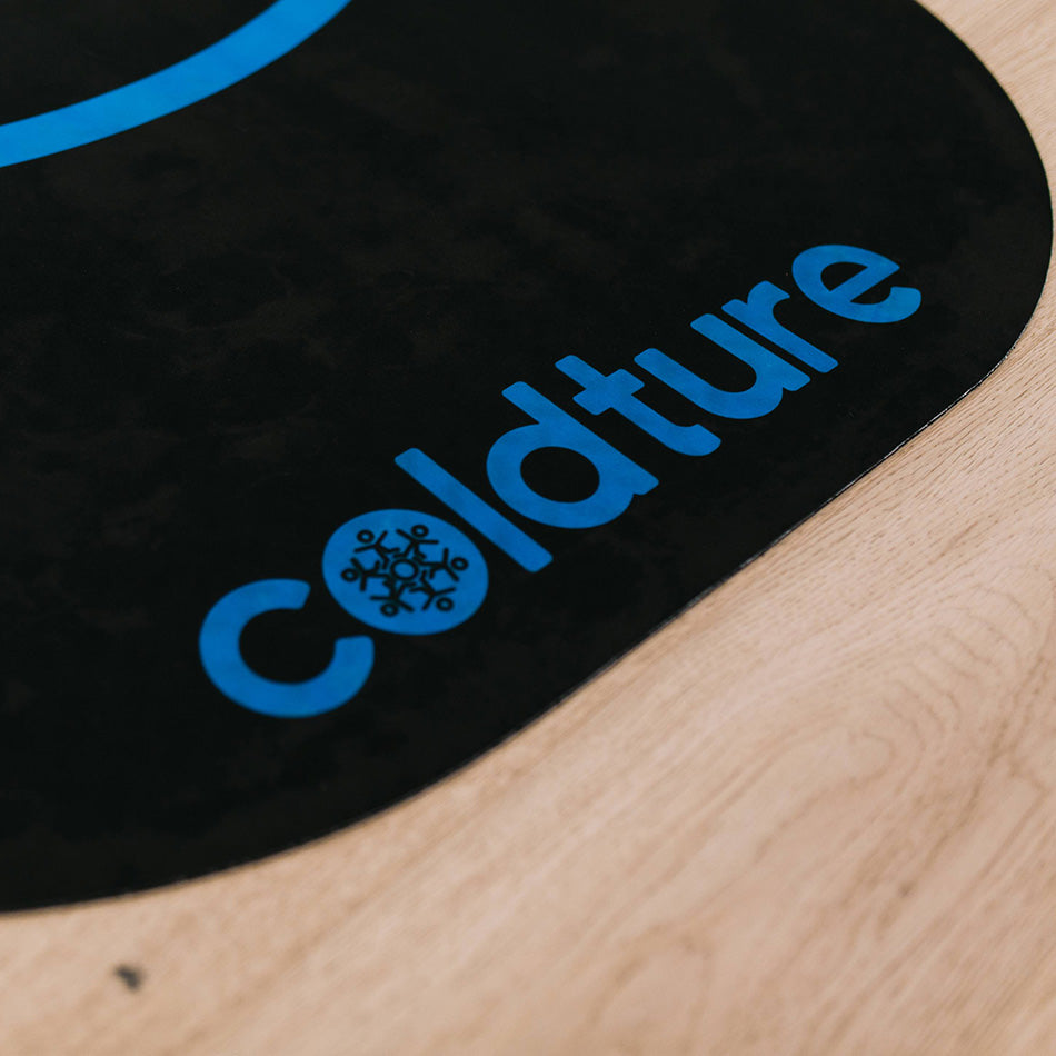 Close-up of the Coldture Dry Mat featuring a black surface with blue text and logo.
