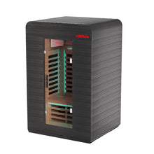 Black infrared sauna in home gym with wooden bench and exercise bike.