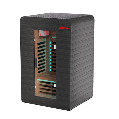 Black infrared sauna in home gym with wooden bench and exercise bike.