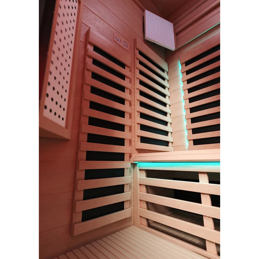 Infrared sauna interior with wooden slats and soft ambient lighting.