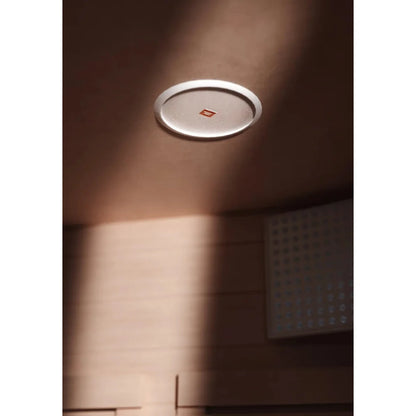 JBL ceiling speaker in a wooden room, featuring a sleek white rim.