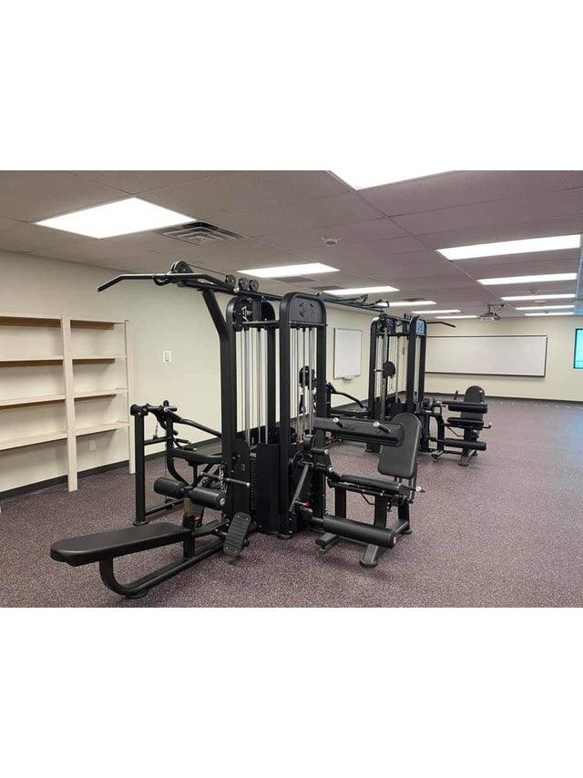 Compact 8-stack black multi-gym station in a spacious weight room.