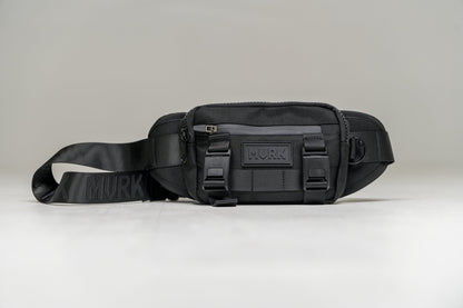 Black waist pack with strap and buckles, featuring a MVRK logo on the front.