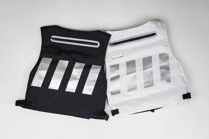 Black and white backpacks with reflective silver stripes and zippers.