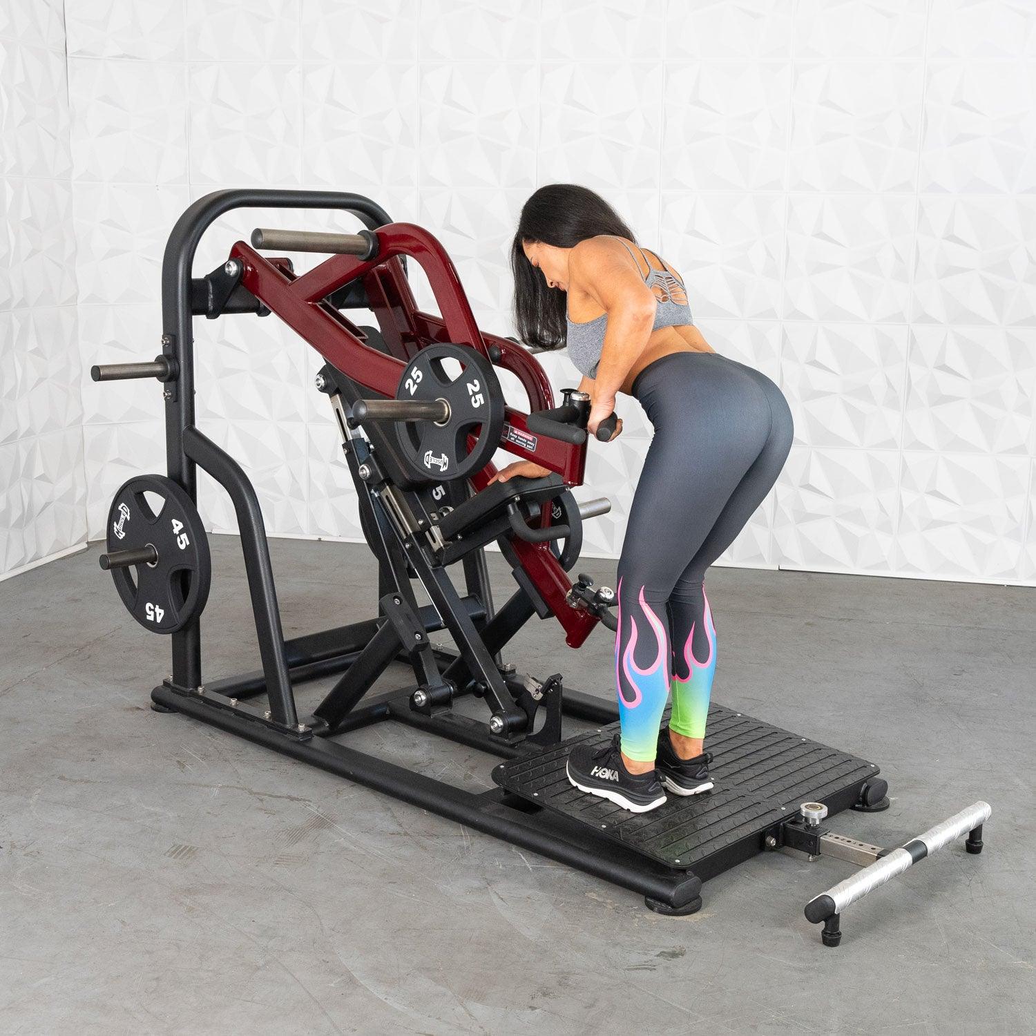 Woman using Plate loaded row machine in colorful leggings for back workout.
