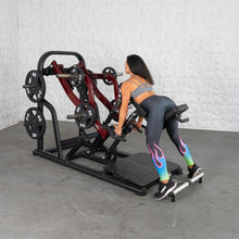 Woman using a Smith machine in colorful leggings for strength training.