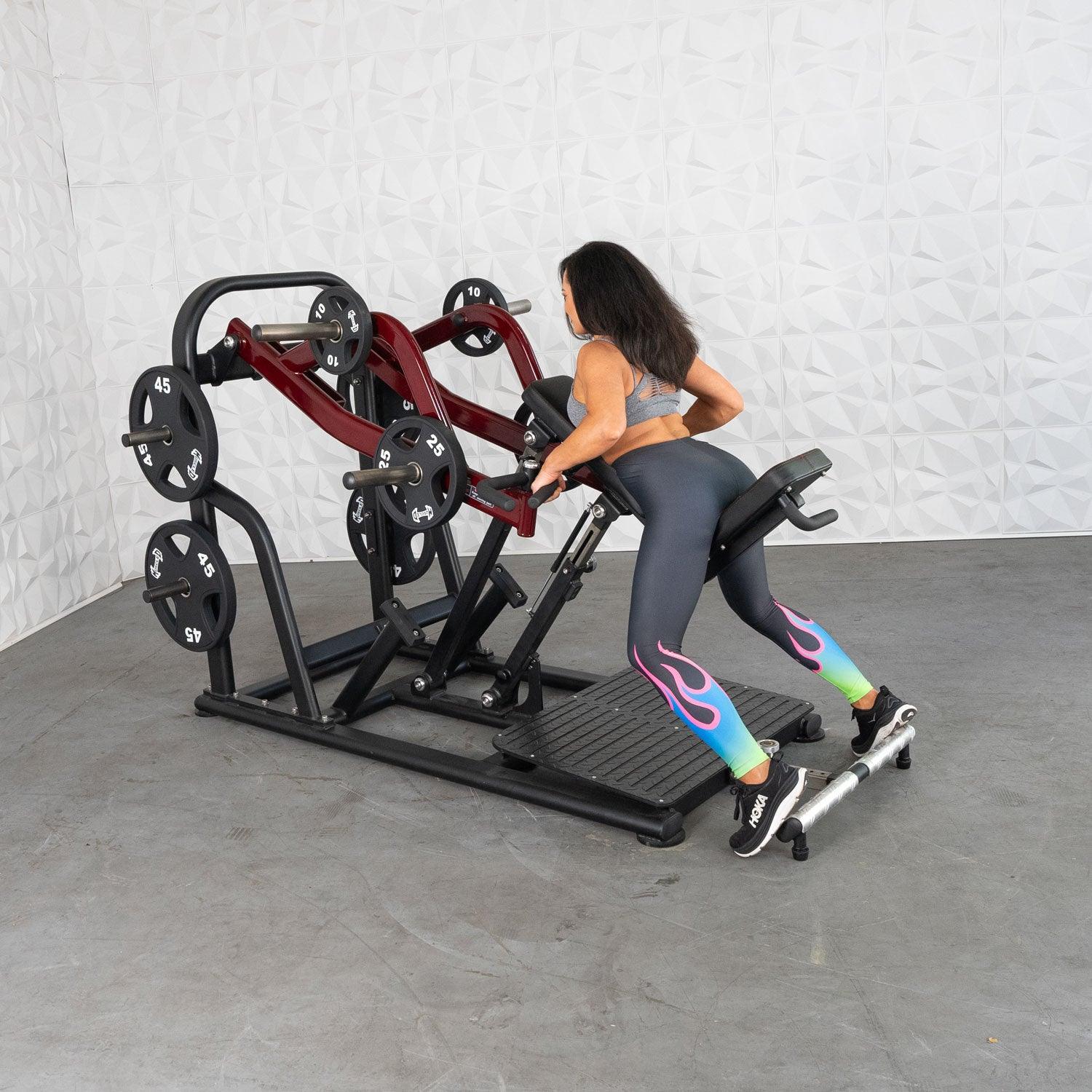 Woman using a black and red plate-loaded row machine for strength training.