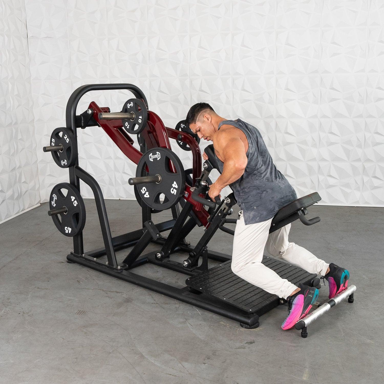 Man using Plate loaded plate-loaded row machine in a gym.