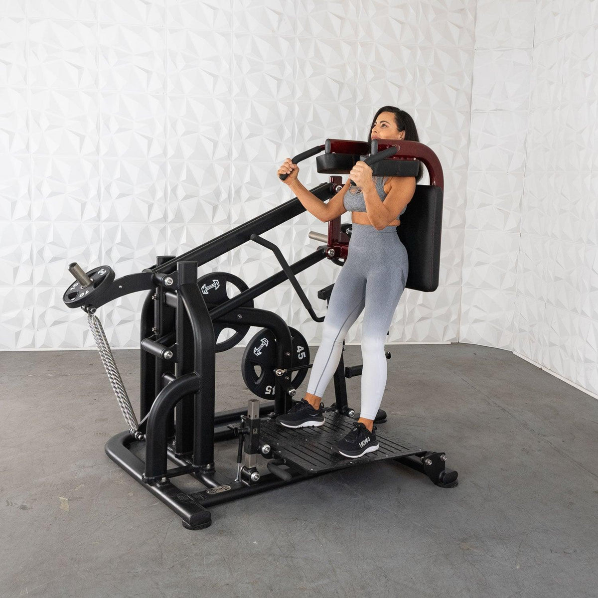 Woman using a leg extension machine in a gym.