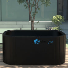 Dreampod Cold Plunge Flex, a sleek black cold plunge tub placed on a wooden deck surrounded by greenery and modern architecture.