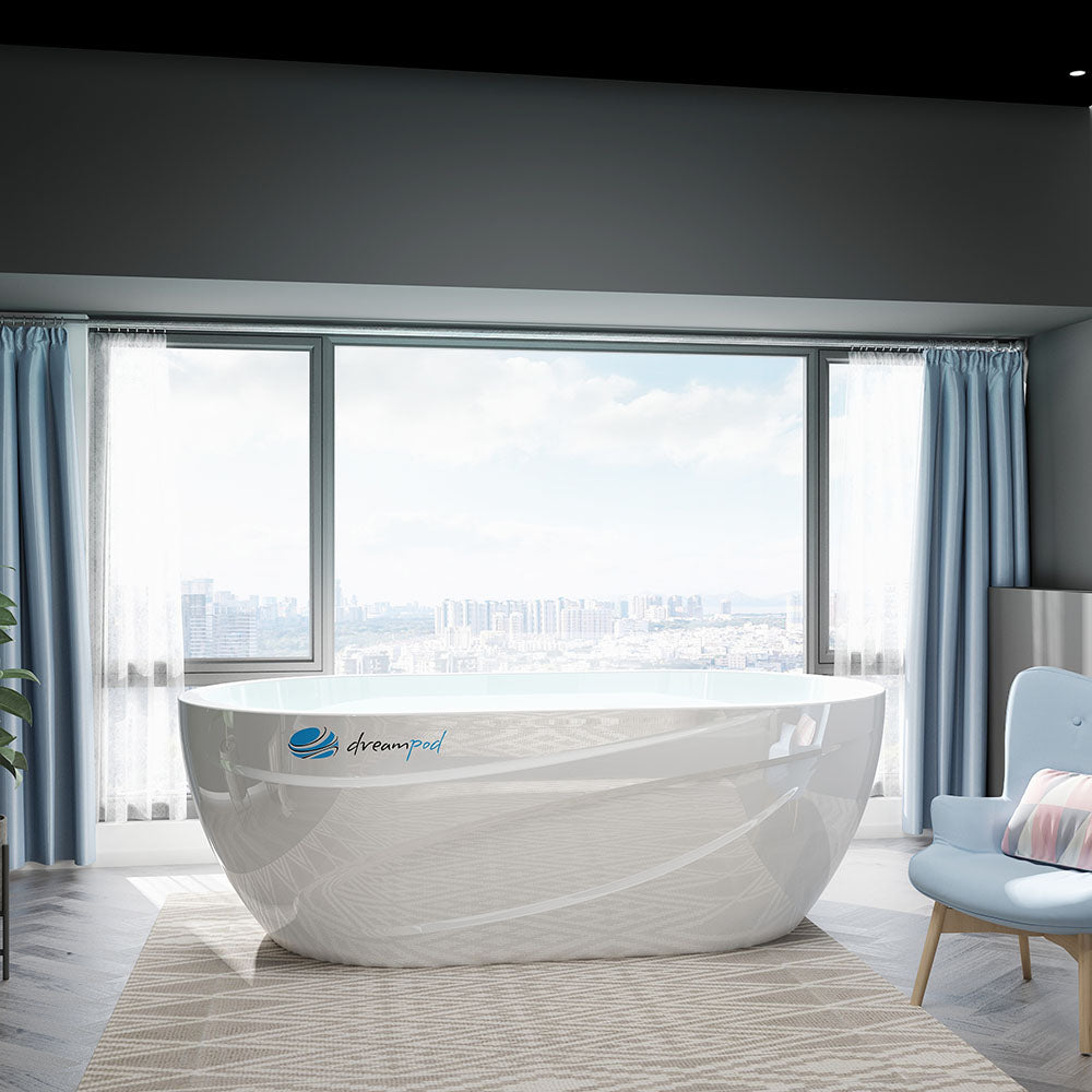 A bright and modern room featuring a Dreampod Commercial Cold Plunge tub, large windows with a city view, and light-colored furnishings, including a blue chair and patterned rug.