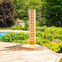 Wooden outdoor shower pillar with rain shower head on a wooden deck