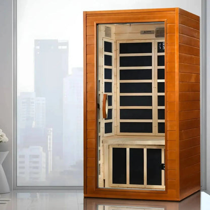 Dynamic Avila 1-2 Person Far Infrared Sauna displayed indoors with a cityscape view through a large window.
