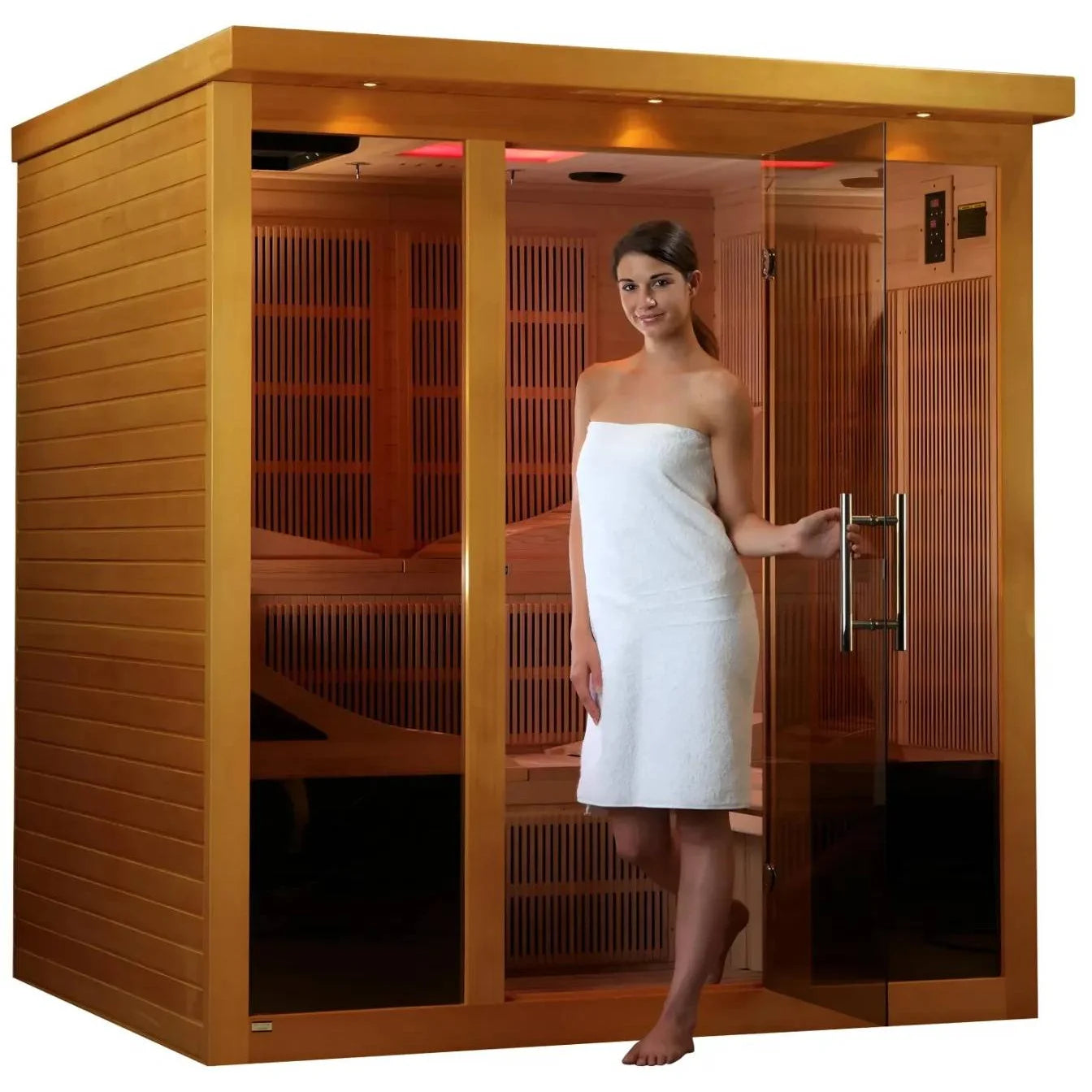 A woman in a white towel standing at the entrance of the Dynamic Monaco 6 Person Far Infrared Sauna, showcasing its wooden exterior and glass door.