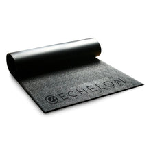 Echelon Bike Mat rolled out on a flat surface, showcasing its textured black design.