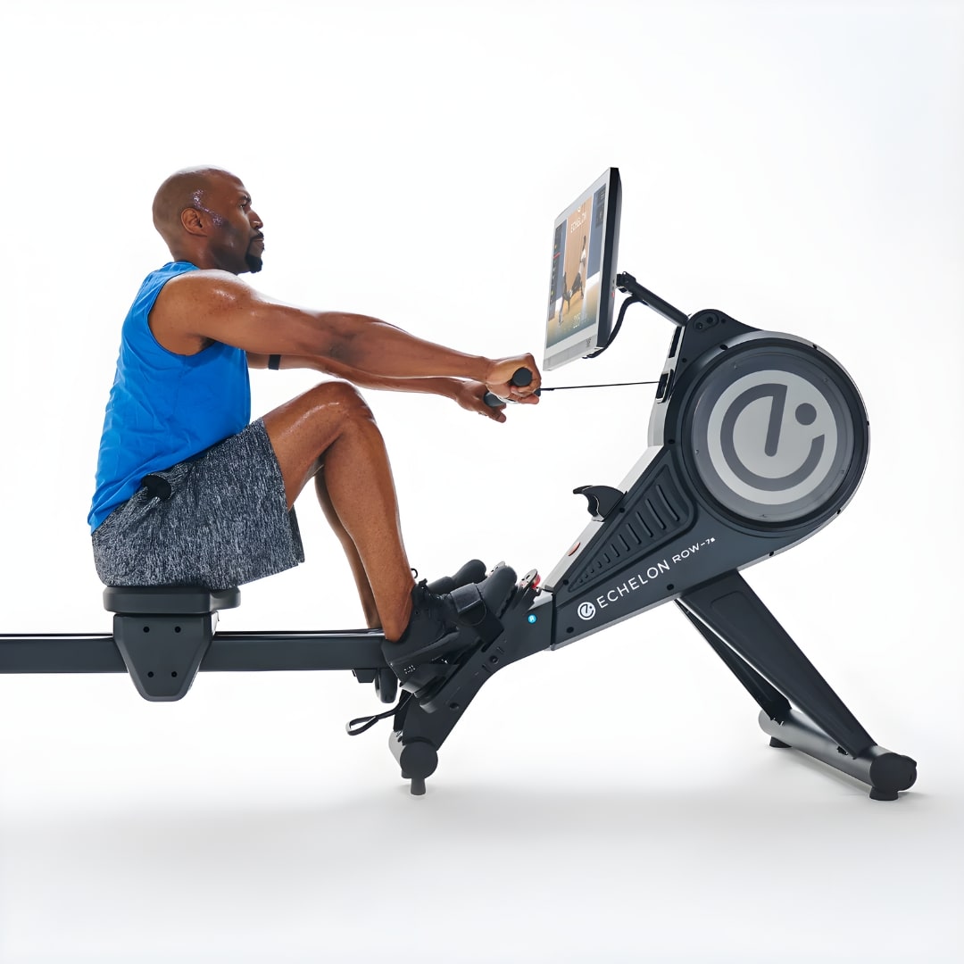 A person using the Echelon Row-7S Rowing Machine, demonstrating proper rowing technique in a workout setting.
