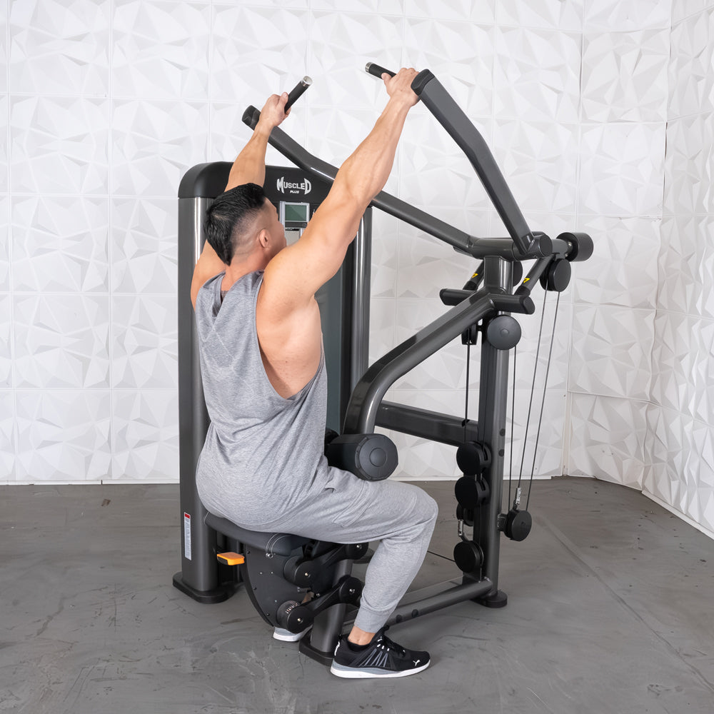 Man using Muscle D fitness machine in gray gym attire.