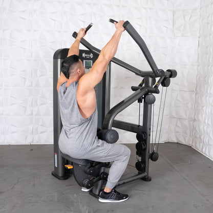 Man using Muscle D fitness machine in gray gym attire.