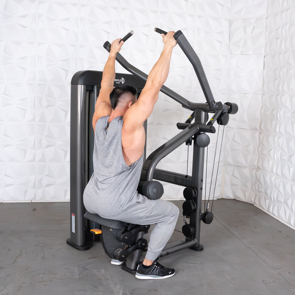 Man using Muscle D Elite seated row machine in gray workout gear.