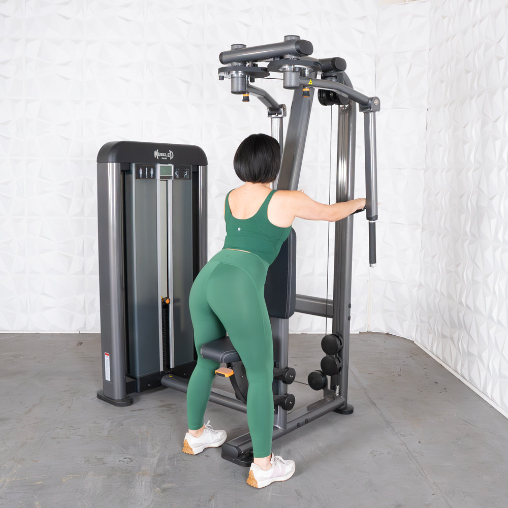 Woman using Elite Plus Pec/Rear Delt machine in gym.