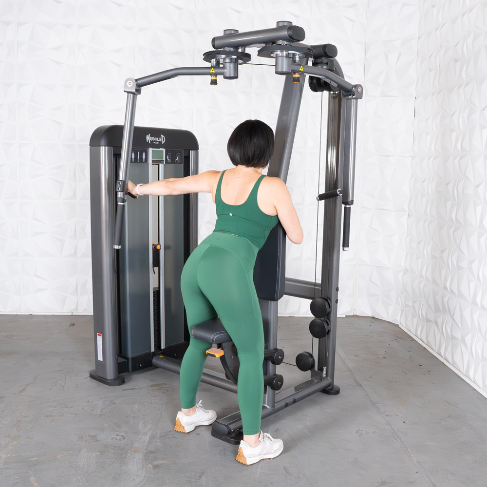 Woman using Elite Plus Pec-Rear Delt machine at the gym.