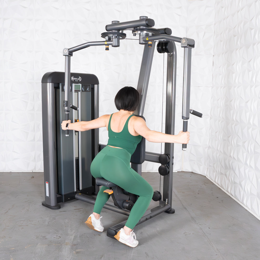 Woman on Elite-Plus Pec-Rear Delt machine in gym.