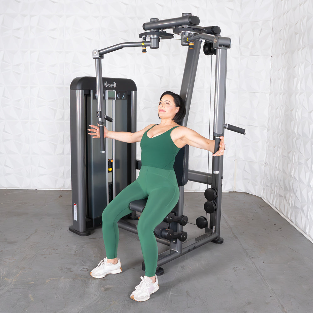 Woman exercising on Elite Plus Pec-Rear Delt machine at the gym.