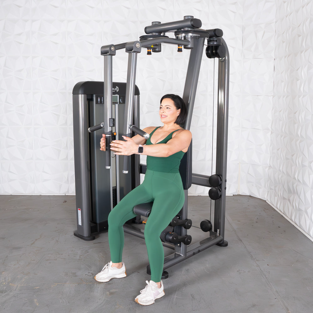 Woman uses Elite Plus Pec–Rear Delt machine for chest/rear delt workout.