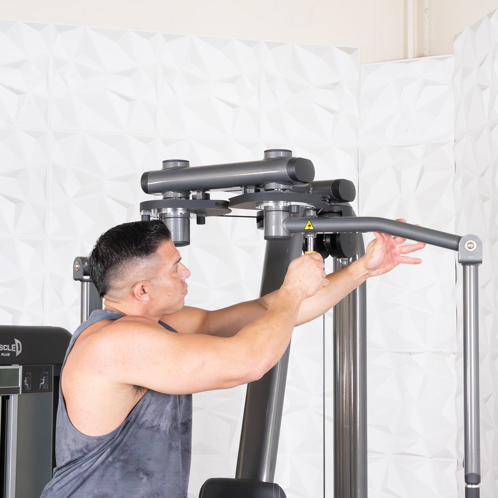 Man uses Elite-Plus Pec & Rear Delt gym machine.