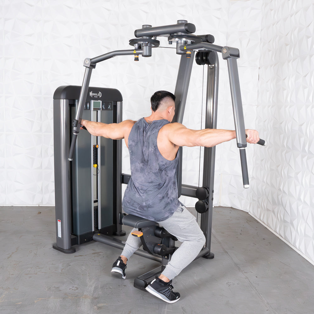 Man using a multi-press chest/rear delt machine at gym.