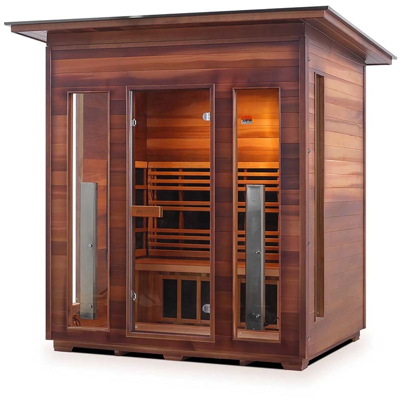 Outdoor wood infrared sauna with glass doors and warm interior lighting.