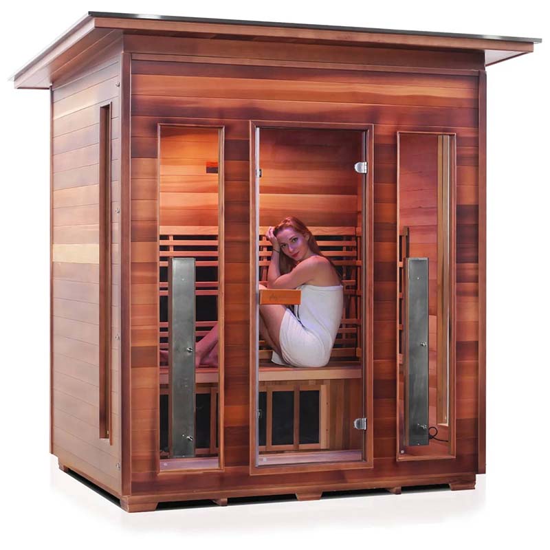 Redwood infrared sauna with a woman relaxing inside, featuring multiple glass doors for easy access.