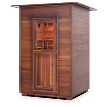 Cedar sauna with wooden slatted door and side panels ideal for relaxation and wellness.