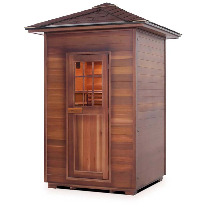 Outdoor cedar wood sauna with a sloped roof and windowed door.