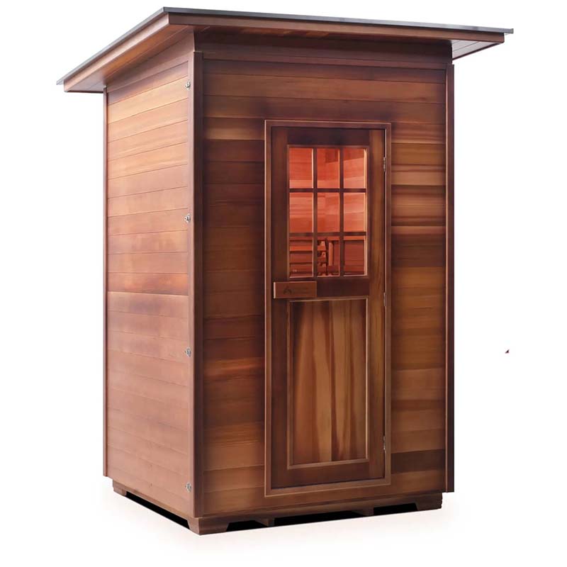 Cedar sauna cabin with glass-paneled door for home use.