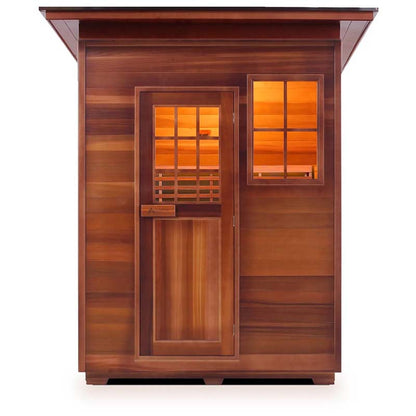 Traditional cedar sauna cabin with warm interior light and slatted window design.