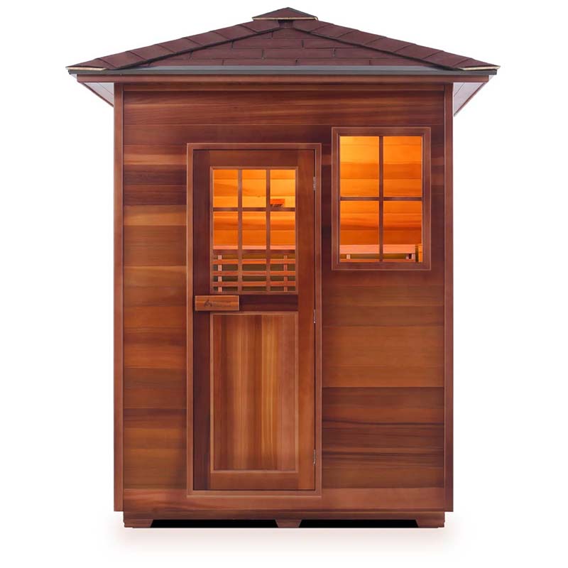 Cedar infrared sauna with wooden front door and window showcasing warm interior lighting.