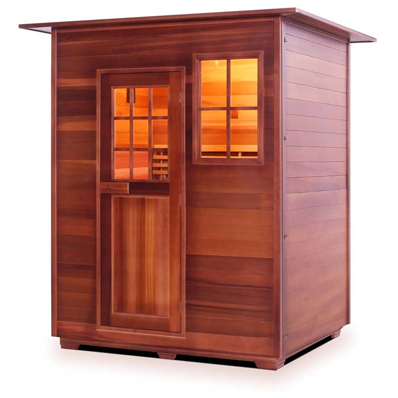 Wooden infrared sauna cabin with warm interior lighting.