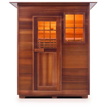 Luxurious cedar home sauna with warm interior light through glass window and door.