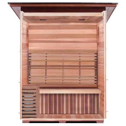Indoor infrared sauna with cedar wood interior and built-in bench.