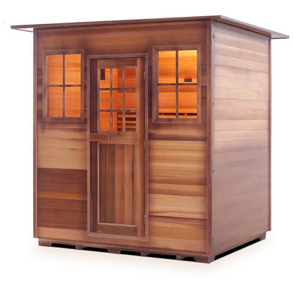 Outdoor cedar sauna with glass windows and warm interior lighting.