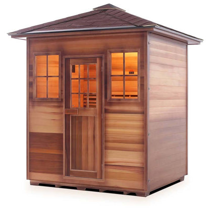 Cedar sauna cabin with glass windows and door, warm interior lighting.