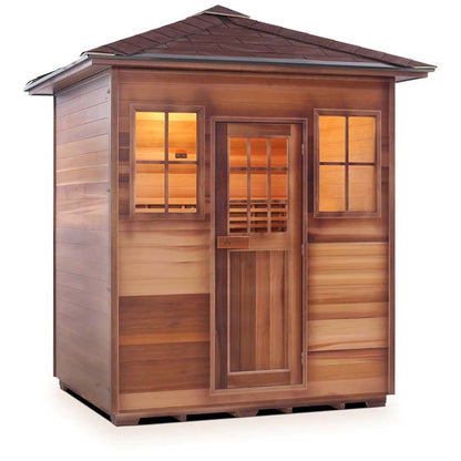 Cedar sauna with warm interior lighting and shingled roof.