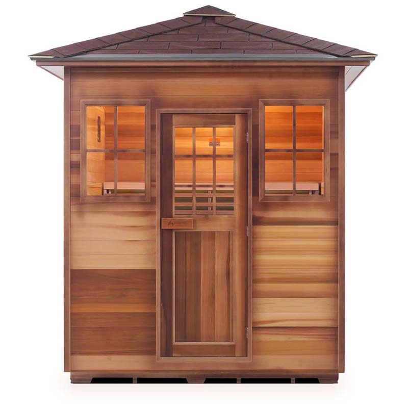 Outdoor cedar sauna with shingled roof and glass windows, perfect for garden relaxation.